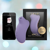 The LELO Sona 3 - Violet Dusk, featuring advanced SenSonic technology, is displayed beside its black packaging and a smartphone showing the app. The softly blurred pastel background enhances the scene. The LELO Sona 3 - Violet Dusk, featuring advanced SenSonic technology, is displayed beside its black packaging and a smartphone showing the app. The softly blurred pastel background enhances the scene.