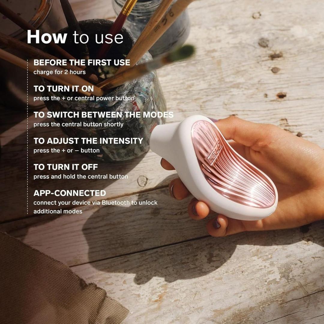A hand holds the LELO Sona 3 - Cream, a small, white and rose gold device. On-screen instructions show how to charge, power on, adjust intensity, change modes, turn off, and connect to the Bluetooth app. A hand holds the LELO Sona 3 - Cream, a small, white and rose gold device. On-screen instructions show how to charge, power on, adjust intensity, change modes, turn off, and connect to the Bluetooth app.