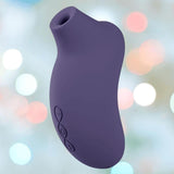 The LELO Sona 3 - Cyber Purple is a curved silicone device with three side buttons and SenSonic technology, shown against a soft, pastel-lit background. The LELO Sona 3 - Cyber Purple is a curved silicone device with three side buttons and SenSonic technology, shown against a soft, pastel-lit background.