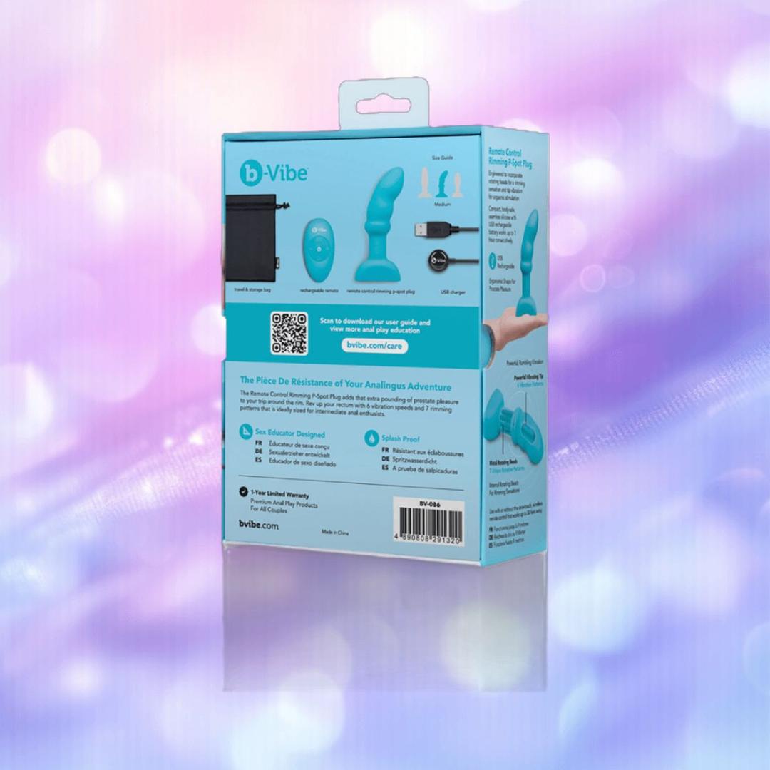 Back of B-Vibe Remote Rimming P-Spot Plug packaging shown against a purple bokeh background, displaying product images, key features, QR code, website link, and usage instructions for this turquoise device. Back of B-Vibe Remote Rimming P-Spot Plug packaging shown against a purple bokeh background, displaying product images, key features, QR code, website link, and usage instructions for this turquoise device.
