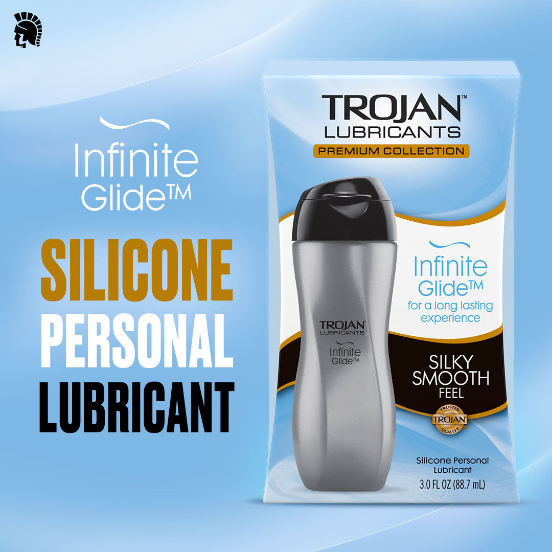 The box and bottle of Trojan Infinite Glide - Premium Silicone-Based Personal Lubricant (3oz) by Trojan are displayed on a light blue background. Text highlights “Silicone-Based Personal Lubricant” and features such as “Silky Smooth Feel.” This premium lubricant provides a long-lasting experience designed for ultimate comfort.