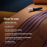 The LELO Billy 2 Vibrating Prostate Massager in deep blue, featuring an ergonomic design, sits on a striped blanket. Instructions explain charging, LED status, vibration settings, intensity control, and power functions.