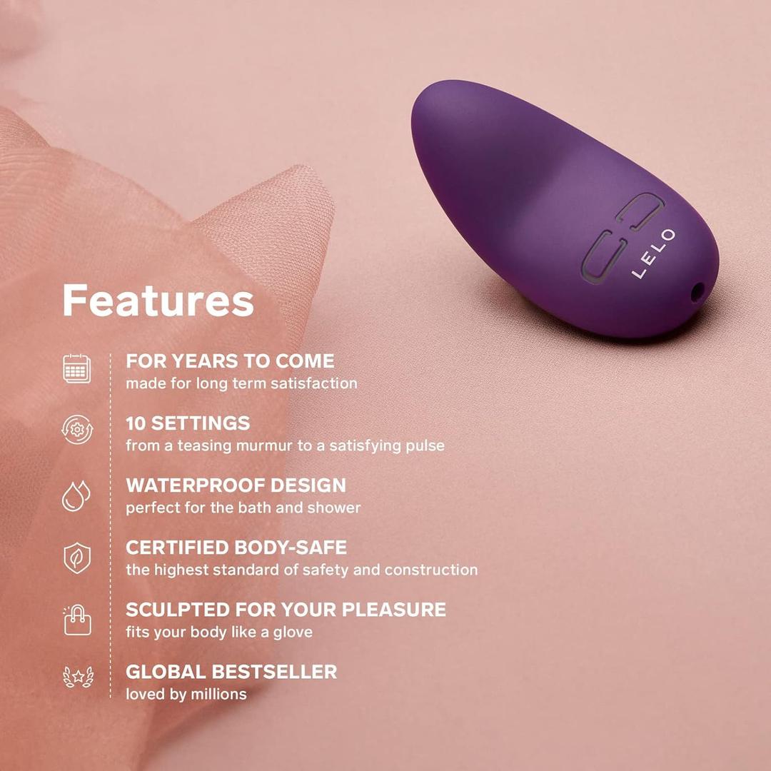 A LELO Lily 3 - Calm Lavender mini vibrator rests on soft pink fabric. Text beside it highlights durability, 10 vibration modes, waterproof design, body-safe materials, ergonomic shape, and worldwide popularity.