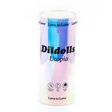 A cylindrical, iridescent packaging labeled "Dildolls 'Utopia' Silicone Dildo with Suction Base" showcases features such as "100% liquid silicone," "Anal safe," and "Suction cup dildo." The top and bottom edges of the packaging are adorned with the phrase "Love to Love." Additionally, it is harness compatible for versatile play.