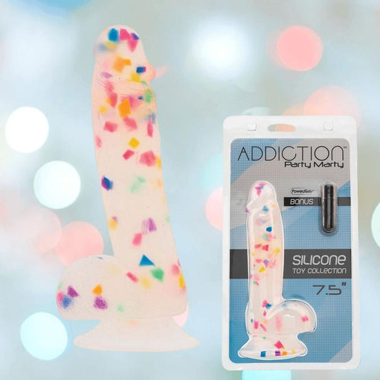 The BMS Addiction Party Marty Vibrating Dildo - Rainbow 7.5" in frosted silicone is shown with its colorful box and a bonus item, harness-compatible, set against a softly lit, blurred background. 1080