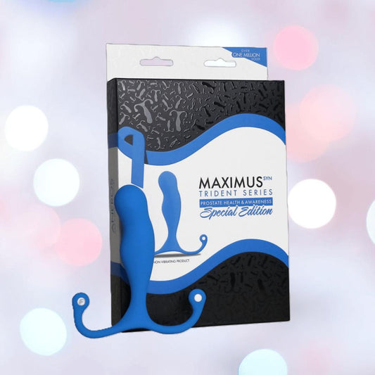 The Aneros Maximus Syn Trident Series Special Edition Blue Silicone Prostate Massager is shown in front of its packaging, set against a light background with soft white bokeh effects. 1080