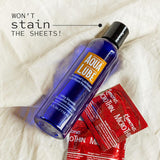 A bottle of Aqua Lube by Kimono Water-Based Personal Lubricant and three red Kimono MicroThin condoms are displayed on a cream-colored fabric background. The image includes the text "Won’t stain the sheets!" in black, promising a silky smooth sensation.