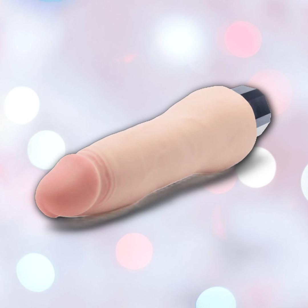 The Blush Novelties Au Naturel Vanilla Ice Vibrating Dildo, featuring lifelike texture and a realistic flesh tone, is displayed on a soft pastel background with circular light spots.