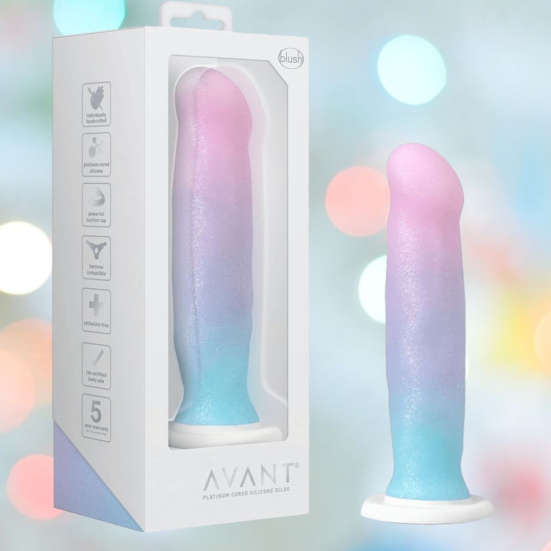 The Avant D17 'Lucky' Non-Porous Silicone Dildo by Avant stands beside its packaging, showcasing body-safe silicone and a 5-year warranty against a softly glowing, colorful background.