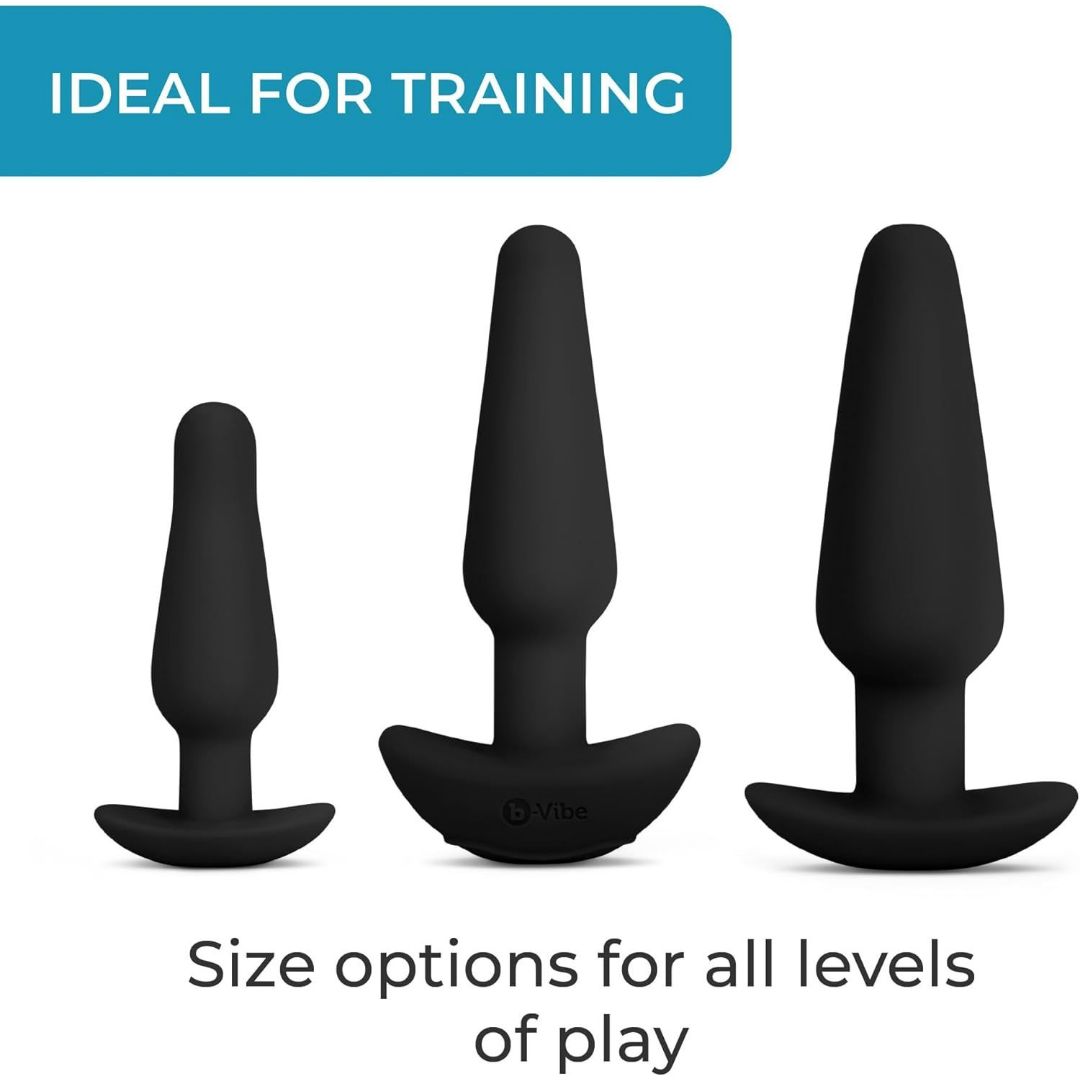 The B-Vibe Anal Training Set, featuring three black silicone butt plugs in varying sizes, is showcased vertically against a white background. A blue banner at the top states "Ideal for Training," highlighting this comprehensive kit's suitability for users at any level of experience.