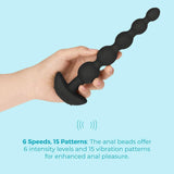 A hand holds the B-Vibe Cinco Beads XL Vibrating Anal Beads - Black by B-Vibe against a light blue background. Six speeds and 15 vibration patterns offer sensational anal play, perfect for exploring new sensations.