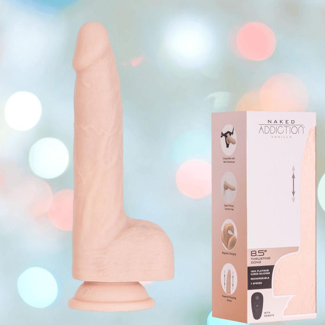 The BMS Naked Addiction Thrusting Dong - Vanilla 8.5" is shown beside its box with product details and images, set against a soft pastel bokeh background, highlighting its lifelike design and quality craftsmanship.