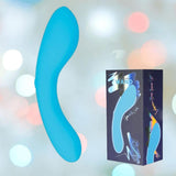 The BMS The Mini Swan Wand Glow in the Dark - Blue vibrator is displayed beside its packaging, which features an image of the product and vibrant text, all set against a softly blurred pastel background.