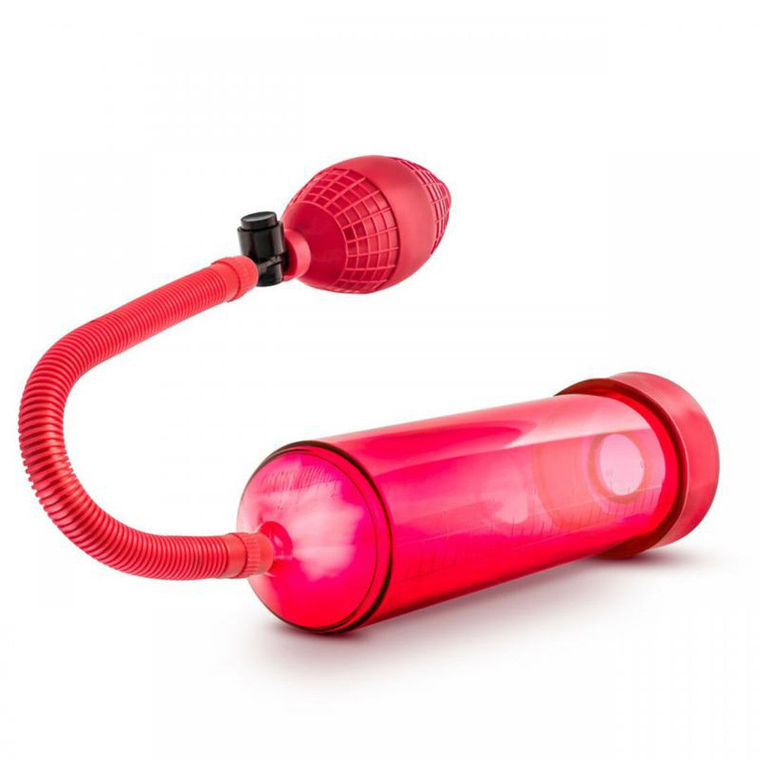 The Performance VX101 Enhancement Pump by Blush Novelties, designed for medical-grade standards with a red cylindrical body, includes a flexible tube and bulb-shaped handle, set against a white background. Plus, enjoy a FREE Stay Hard Cock Ring with your purchase.