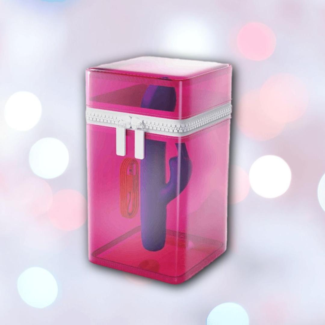 A B Swish Limited Edition Bwild Bunny - Pacific Blue (Dented Box) lies inside a translucent pink zippered container, set against a blurred background with pastel bokeh lights.