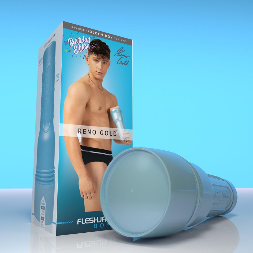 A cylindrical blue Fleshjack Boys Reno Gold: Realistic Male Masturbator Cake Butt BIRTHDAY EDITION in the foreground, with its product packaging featuring a man in black underwear and the text “Birthday Edition” in the background.