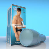 A cylindrical blue Fleshjack Boys Reno Gold: Realistic Male Masturbator Cake Butt BIRTHDAY EDITION in the foreground, with its product packaging featuring a man in black underwear and the text “Birthday Edition” in the background.