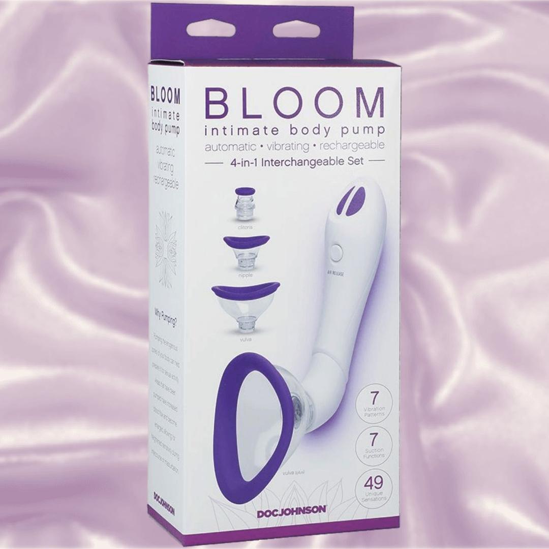 The Bloom Rechargeable Intimate Body Pump - Purple by Doc Johnson comes with four interchangeable cups and offers automatic, vibrating, and gentle suction functions. The box displays the white and purple device and highlights its key features.