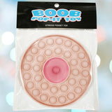 The Kheper Games Boob Pop-It Toy is a round, flesh-toned fidget toy with a pink center, packaged in a clear bag labeled "BOOB POP-IT TOY Stress Fidget Toy"—perfect for stress relief.