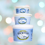 Three stacked containers of Boy Butter "H2O" Water-Based Lubricant, offered by Boy Butter and crafted with natural ingredients, are displayed against a blurred, vibrant backdrop with circular light spots, highlighted by their distinctive light blue design.