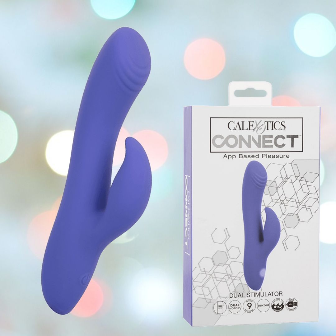 The CalExotics Connect Dual Stimulator in a rich shade of purple is elegantly showcased next to its packaging box, which emphasizes its app-controlled features and diverse vibration patterns. The product image is set against a backdrop of soft, colorful bokeh lights, captivating viewers with each look.