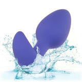 The CalExotics Connect Tapered Probe App Controlled Anal Vibrator by CalExotics splashes into clear blue water, surrounded by droplets and waves, with a white background.