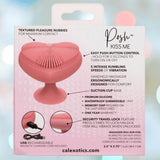 The CalExotics Posh Kiss Me Handheld Massager features textured pleasure nubbies, a suction base, 5 vibration speeds, push-button control, waterproof design, travel lock, and USB rechargeability. Packaging displays these features.