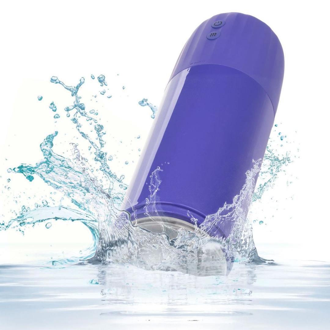 The CalExotics Connect Stroker with Vibration and Suction, a purple electronic device with two buttons, splashes into clear water, sending droplets and ripples across a white background.