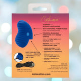 Product packaging for the CalExotics Cashmere Dual Finger Massager, blue in color, highlights 10 speeds, silicone material, USB rechargeable design, and a travel lock. The background features softly blurred colorful lights.