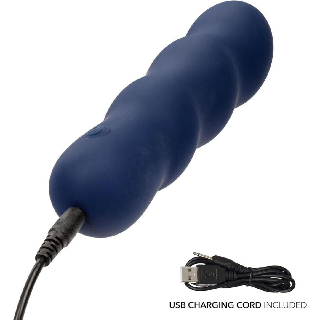 The CalExotics Cashmere Satin Swirl G is a dark blue, rounded silicone personal massager with a wavy design, shown with its USB charging cord attached. Another image displays the USB charging cord separately.