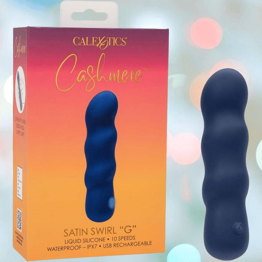 A blue, wavy silicone vibrator from CalExotics, the Cashmere Satin Swirl G, stands upright by its colorful box. It features 10 speeds, is waterproof, and is USB rechargeable. 1080