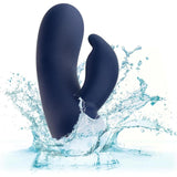 The CalExotics Cashmere Silk Bunny Rabbit Vibrator, a dark blue silicone dual-ended toy, splashes into clear water and creates droplets and ripples against a white background.