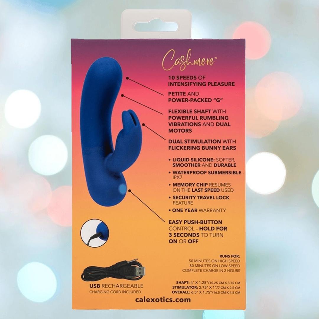 The back of the Cashmere Silk Bunny Rabbit Vibrator by CalExotics shows the blue vibrator, product features with arrows, a USB charging cable, and text highlighting multiple settings and silicone material over an orange to purple gradient background.