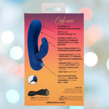 The back of the Cashmere Silk Bunny Rabbit Vibrator by CalExotics shows the blue vibrator, product features with arrows, a USB charging cable, and text highlighting multiple settings and silicone material over an orange to purple gradient background.