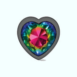 The Cheeky Charms Gunmetal Large Metal Butt Plug - Heart-Shaped Rainbow features a multicolored, faceted heart-shaped gemstone with vibrant shades of red, pink, green, and blue, set within a dark, smooth heart-shaped frame. This stunning piece of anal jewelry is displayed elegantly against a light background.