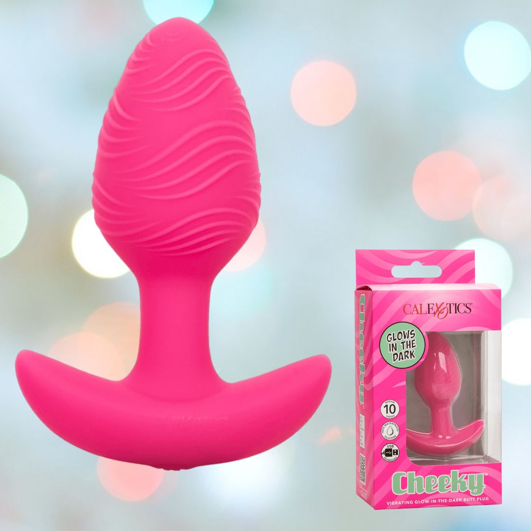 A pink, textured butt plug crafted from body-safe silicone is shown against a blurred background. The packaging features the CalExotics Cheeky Vibrating Glow-In-The-Dark Butt Plug with its transparent section and brand label. Ideal for enhancing anal play!