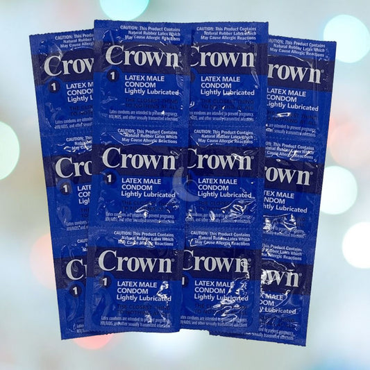 A grid of blue, individually packaged Crown Skinless Skin Ultra-Thin Condoms, crafted from Japanese latex for a natural feel, is arranged on a blurred background with circular light spots. The front of each package displays product details and safety information in white text. 1080