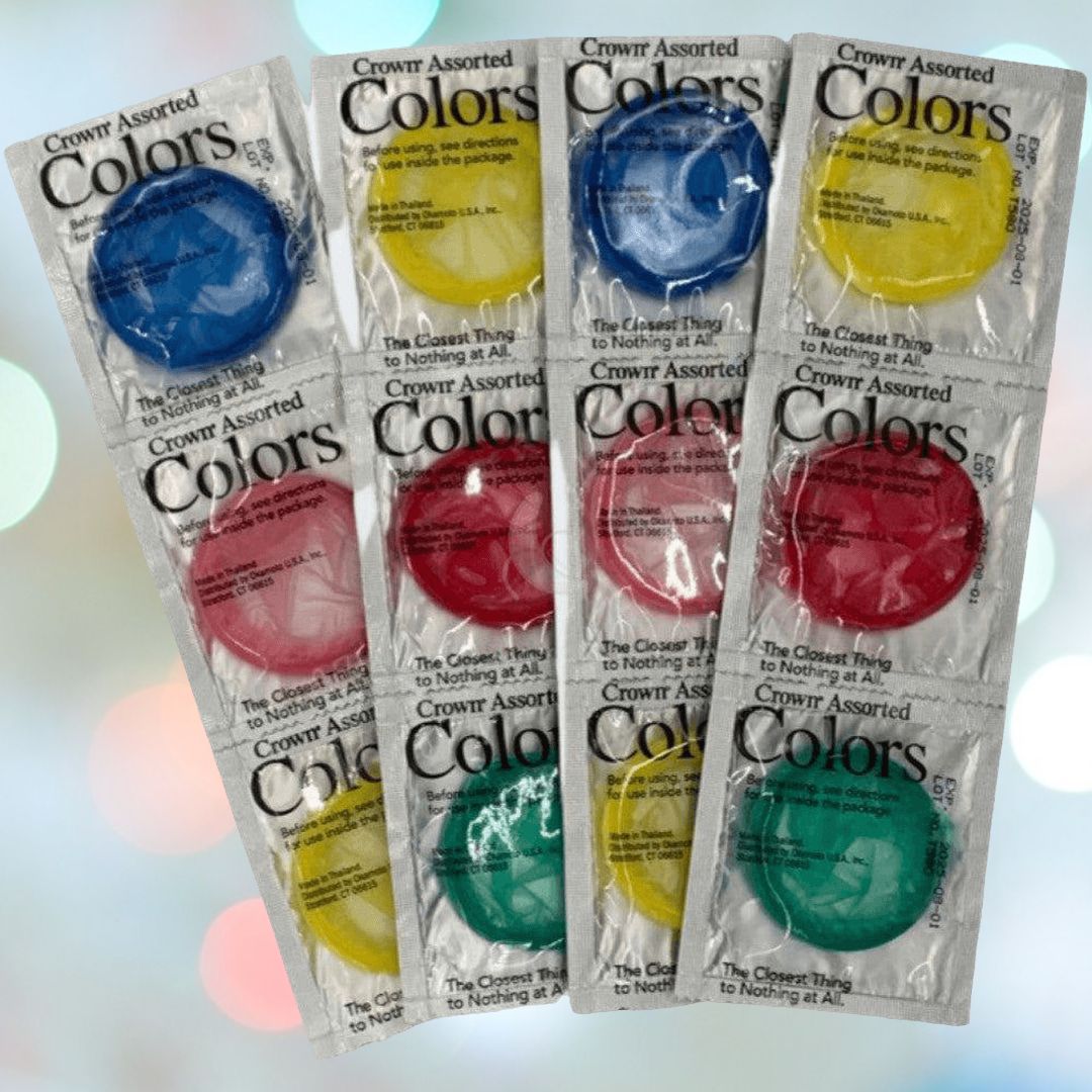 A pack of Crown Assorted Colors Lubricated Latex Condoms arranged vertically in blue, red, yellow, and green colors. Each lubricated condom is individually wrapped in clear packaging with text printed on it. The background features a blurred gradient of soft colors, adding a subtle elegance to the display.