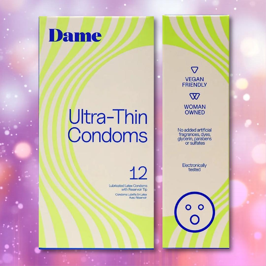 Two boxes of Dame Ultra-Thin Vegan Friendly Latex Condoms by Dame are displayed against a pink and purple bokeh background, featuring green accents and text highlighting key qualities such as “Vegan Friendly,” “Woman Owned,” and “Electronically Tested.” Enjoy confidence with these premium vegan condoms crafted for optimal comfort and reliability.