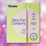 Two boxes of Dame Ultra-Thin Vegan Friendly Latex Condoms by Dame are displayed against a pink and purple bokeh background, featuring green accents and text highlighting key qualities such as “Vegan Friendly,” “Woman Owned,” and “Electronically Tested.” Enjoy confidence with these premium vegan condoms crafted for optimal comfort and reliability.