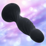 The Deep Swirl Vibrating Probe by CalExotics, a black silicone toy with a wavy texture, is displayed against a softly blurred pastel background featuring pink, purple, and blue hues with white light spots.