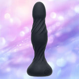 The Deep Swirl Vibrating Probe by CalExotics is a black, silicone, textured toy with a curved shape and power button at the base, shown against a blurred pastel purple and pink background.