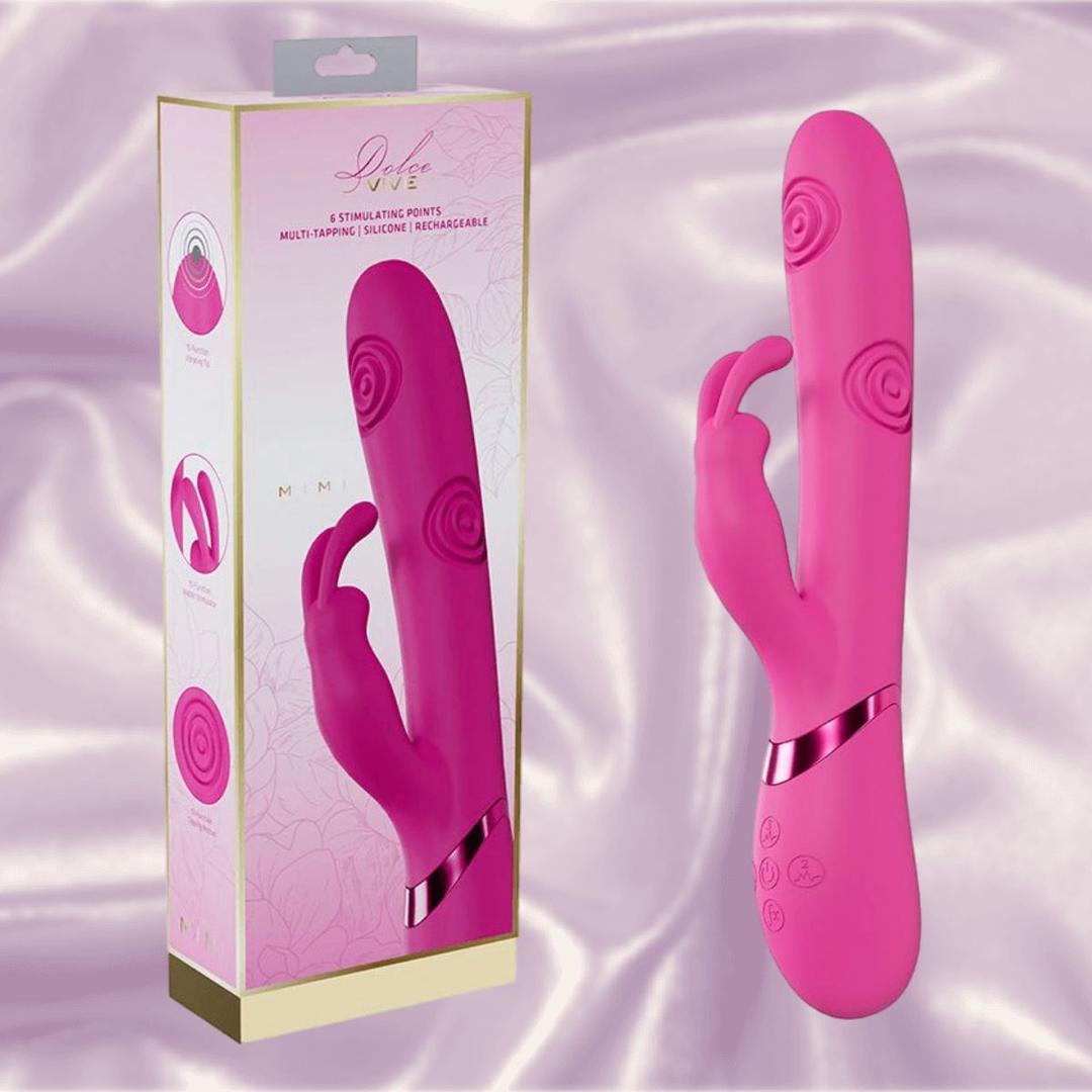 The Dolce Vive Mimi Rechargeable G-Spot Vibrating and Tapping Rabbit-Pink by Shots America features a dual design with textured patterns, shown beside its branded packaging against a silky light purple backdrop.