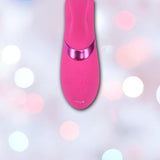 A close-up of the Dolce Vive Fiore Rechargeable G-Spot Air Wave Vibrating and Tapping Clit by Shots America, featuring control buttons and branding, set against a soft background with pastel pink, white, and blue bokeh lights.
