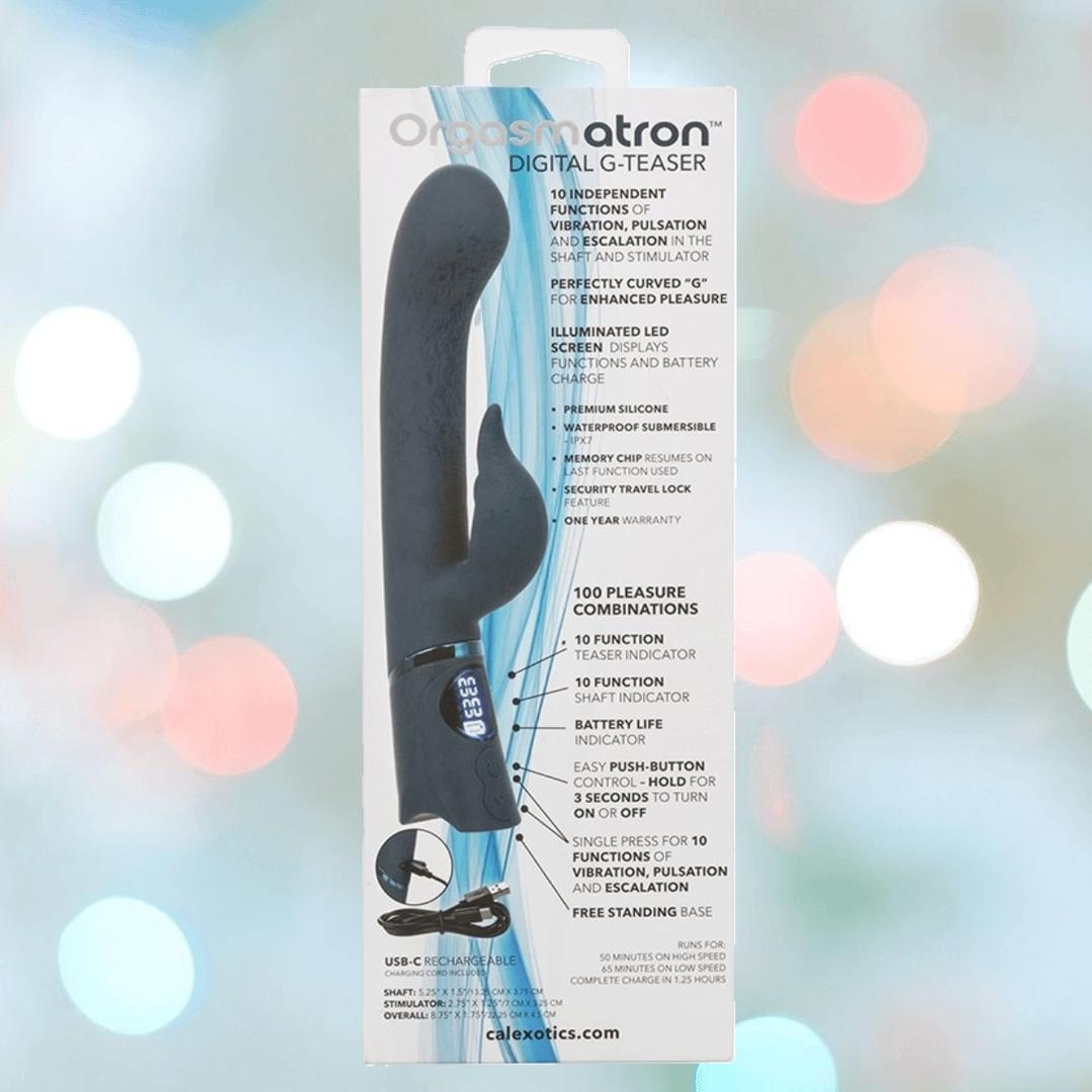The Orgasmatron Digital G-Teaser by CalExotics is shown in its white and blue box, highlighting 10 functions, USB charging, an ergonomic design, and a digital display, with detailed product info on the packaging.