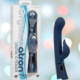 A boxed and unboxed blue silicone vibrator, the CalExotics Orgasmatron Digital G-Teaser, appear side by side against a blurred pastel background. The box highlights its digital features and 100 unique pleasure combinations.