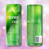 Two green bottles of Durex Touch & Play Personal Lubricant with Aloe are displayed against a soft pink background with gentle bokeh effects, one showing the front and the other the back. The label spotlights the soothing benefits of this aloe-infused lubricant from Durex, designed for both massage and intimate pleasure.