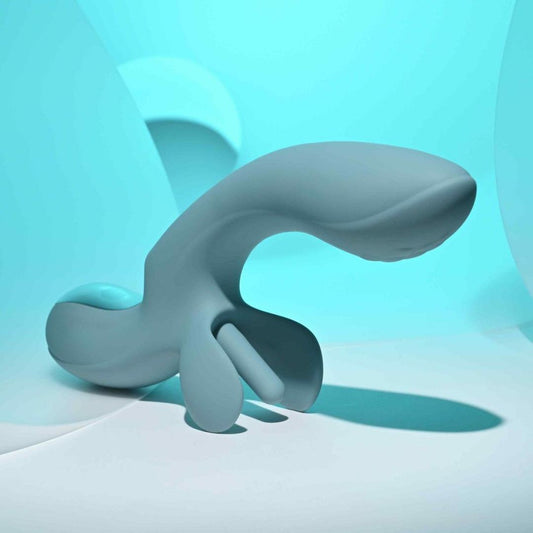 The Evolved Novelties Evolved Take Your Flick features a smooth, abstract teal design with curved and rounded shapes, resembling a customizable pleasure device against a soft blue background with gentle lighting. 1080