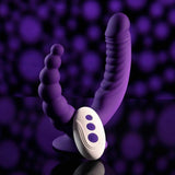 The Evolved Novelties Evolved The Rider is a double-ended vibrator in purple silicone with ribbed and beaded details, shown with a white remote control against a dark purple, abstract background.