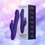 The Femme Funn Booster Rabbit XL Dark Purple, a dual-action vibrator, is pictured beside its packaging on a pastel background. The box displays the product name and features like waterproof silicone.